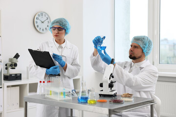 Quality control. Food inspectors checking safety of products in laboratory