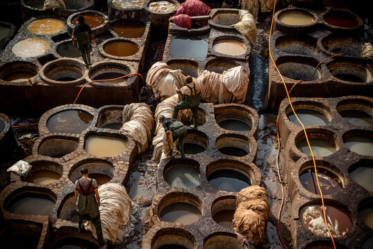 Assembling a clay furnace filled with clay and water: Chouara Tannery in Fes, Morocco