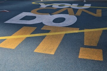 the yellow painted lines on the ground at an airport is visible