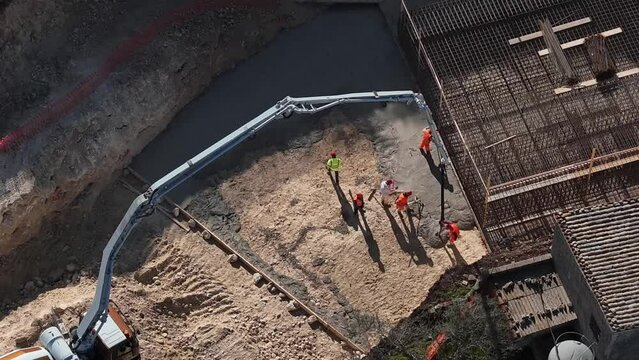 Drone hyper laps of a pouring of concrete in a construction site on a sunny day