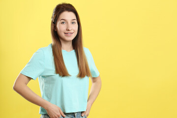 Portrait of smiling woman with dental braces on yellow background. Space for text