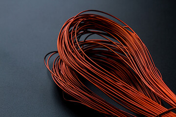 A coil of copper wire on a black background.