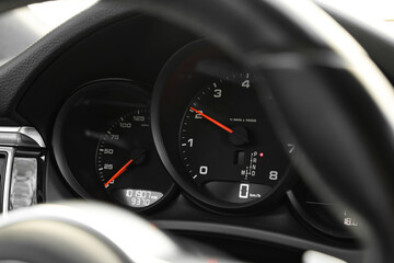 Speedometer and tachometer inside of modern car, closeup