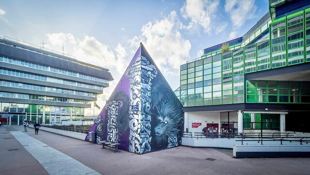 Skyscrapers adorned with vibrant, artistic patterns and green-tinted windows, Cergy, France