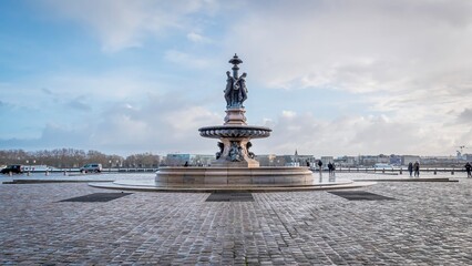 Statue on a fountain on a cobblestone street