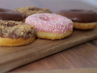 doughnuts on wood board on table at restaurant or bar