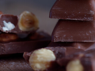chocolate candy pieces with candies and nuts on a wooden table
