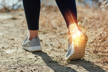 Back, fitness and running with ankle injury of person outdoor in nature for accident, emergency or mistake. Anatomy, exercise and yellow glow with person closeup on ground for physical activity