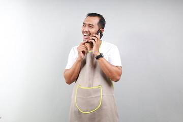 fun Asian man barista bartender barman employee in brown apron white t-shirt work in coffee shop...