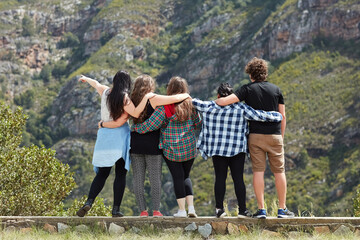 Friends, getaway and hug in outdoor nature, adventure and bonding for love on vacation for freedom. People, back embrace and hiking on weekend trip or holiday, travel and together for relationship