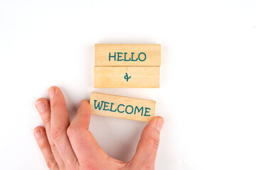 Communication concept, introduction. Words HELLO and WELCOME on wooden blocks on a light background...