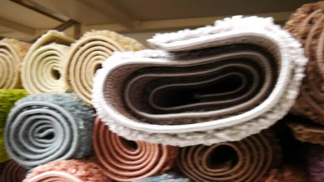 Close-up of many colored carpet rolls
