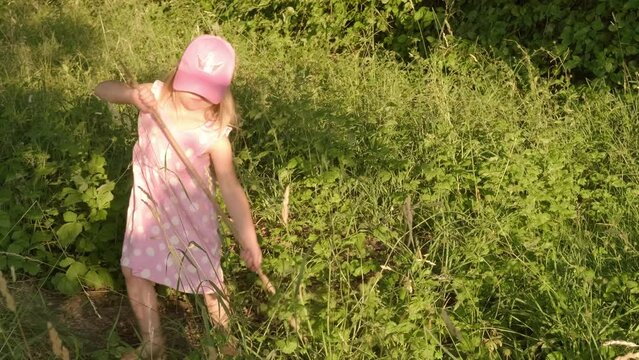 happy romantic girl 4 years old, Cheerful child playing on green sunlit meadow, happy childhood, natural world, seen from behind, Midsummer celebration