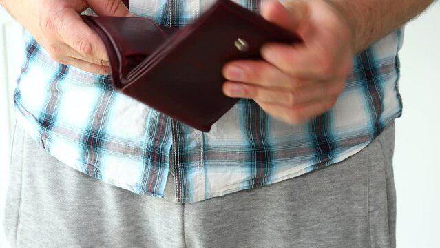 no money in the wallet, Financial concept, empty account, man rummaging through the wallet looking for cash