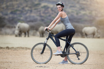 Woman, bicycle and animal in Africa for adventure, nature and travel for cycling safari....