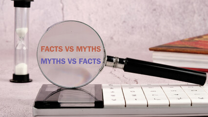 Conceptual symbol. Copy space. Facts vs myths words written through a magnifying glass on a...