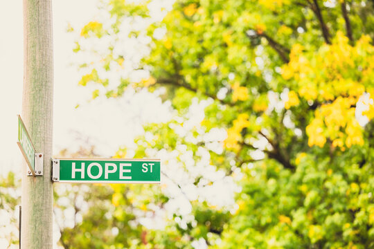 Hope Street sign with leafy green background providing copy space