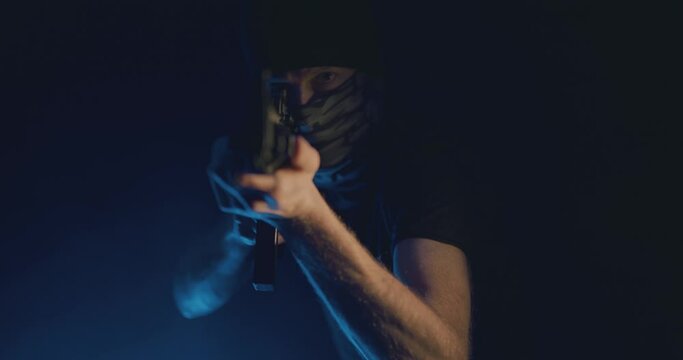 Masked gunman wielding a rifle