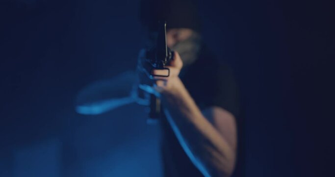 Masked gunman wielding a rifle