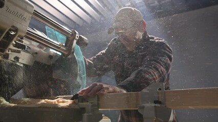 Man Cutting Wood With Powerful Saw Machine