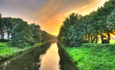 Reflection of the sunset in the water of the Wilhelminakanaal canal near the village of...