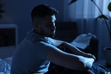 Frustrated man suffering from insomnia at night