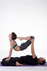 People practicing acro yoga in photo studio. Acro yoga sport theme concept.