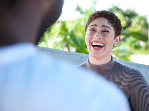 Woman smiling during a conversation outside
