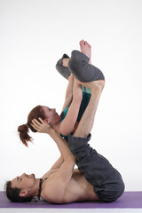 Fototapeta premium People practicing acro yoga in photo studio. Acro yoga sport theme concept.