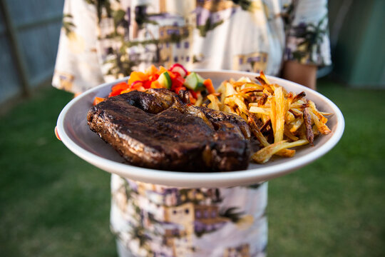 steak, chips and salad on a plate