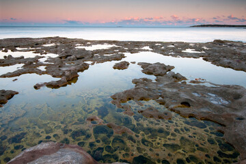Pools on rock platform at sunset