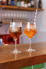 Two colorful cocktails on the bar of a bar ready for drinking, vertical image