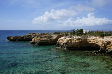 Areal view of The Anguilla Arch merging with the azure waters