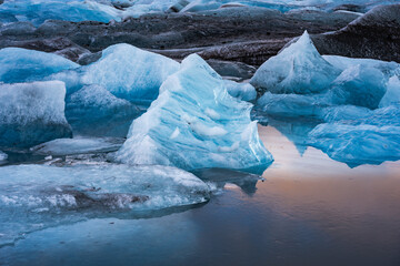 Icebergs reflected in the water near a body of water