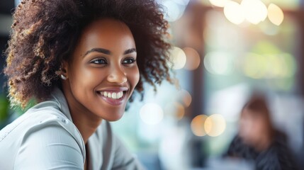 Obraz premium A radiant woman with curly hair smiles warmly inside a well-lit café or casual setting, with soft bokeh lights in the background