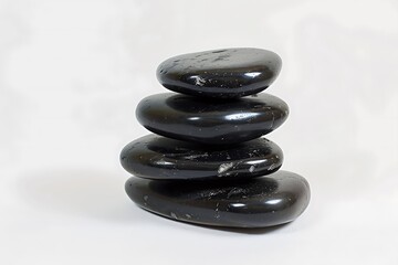 Serene Spa Moment - Stack of Black Massage Stones on White Background