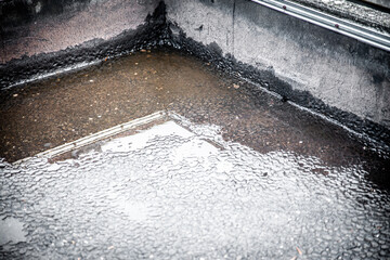 On a flat roof there is water through a blocked drain