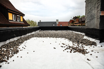 a fleece is rolled out onto which pebbles or river gravel are then poured as drainage