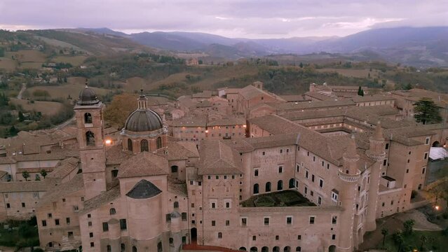 Ascending drone shot of Ducal Palace of Urbino and Cathedral of Santa Maria Assunta, Italy