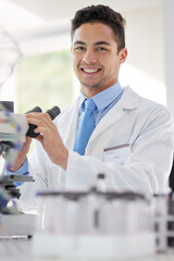 Scientist, microscope and portrait in lab with smile for research study, medical test or investigation. Happy, man and experiment with biotechnology for vaccine, innovation and stem cell development