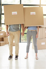 Couple, boxes and moving to new home, holding hands and property success or investment home loan....