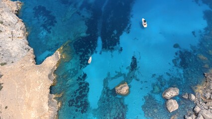 Aerial drone top-down photo of sailboats and yachts in Cala Figuera Beach, Mallorca, Spain