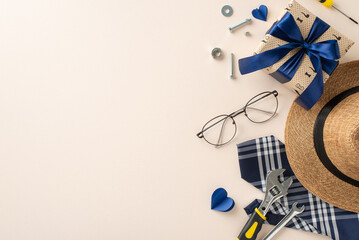 A curated Father's Day setup with stylish hat, glasses, wrapped gift, and tools. Ideal for celebrating dad with a touch of elegance and functionality