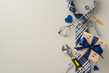 Make Father's Day memorable with our deluxe gift collection. Packed with handy tools and elegant accessories, it's a tribute to Dad's hard work. Top view on pastel grey background with space for ads