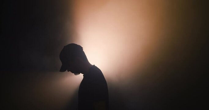 Silhouette of a man in a baseball cap
