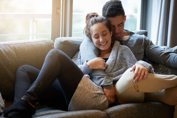 Couple, hug and couch for relax and love, calm and support in home for weekend. Cozy, happy and smile for man and female person for cuddle and living room, romance or sofa in lounge for dating people
