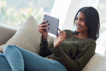 Happy woman, relax and browsing with tablet on sofa for online entertainment, show or streaming...