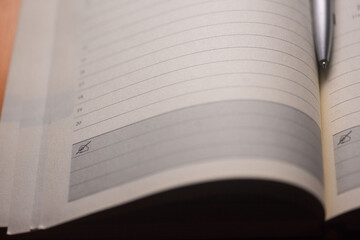 An open journal with pen and warm light illuminating blank pages on a dark table