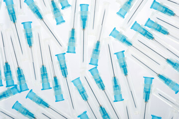 Hypodermic syringes needles on a white background