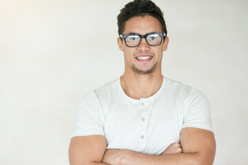 Happy man, portrait and nerd with glasses in confidence for creative mindset on a white studio...